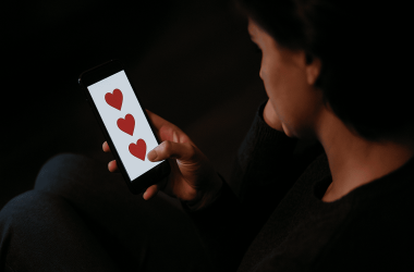 Person messaging on phone unaware of online romance scam